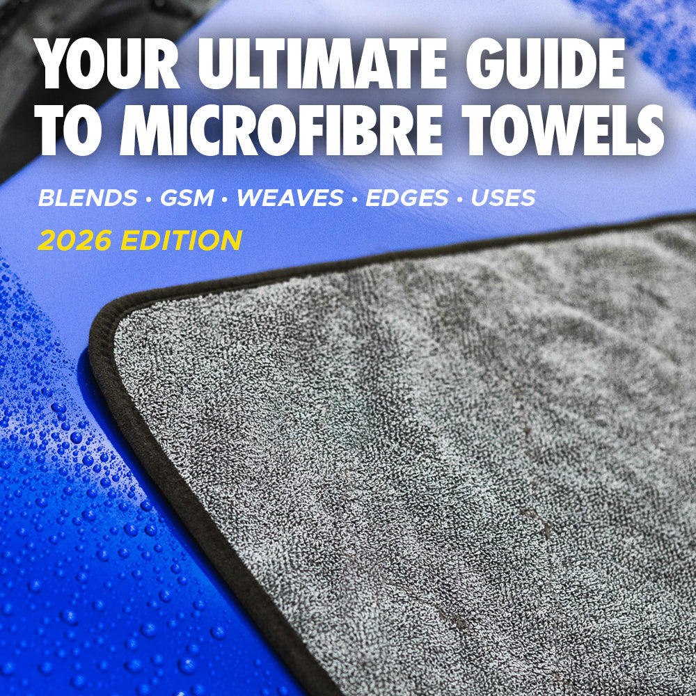 Your ultimate guide to microfibre towels. Grey and black Double Twistress drying towel absorbing water from a blue car's bonnet (hood).